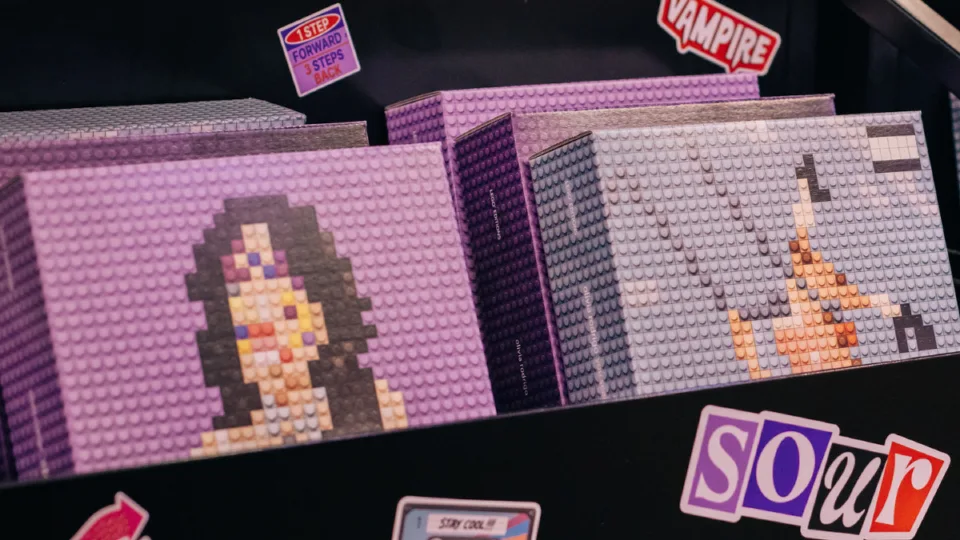 Brick-built promotional LEGO Olivia Rodrigo vinyl record featuring pixelated album art displayed in a record sleeve.