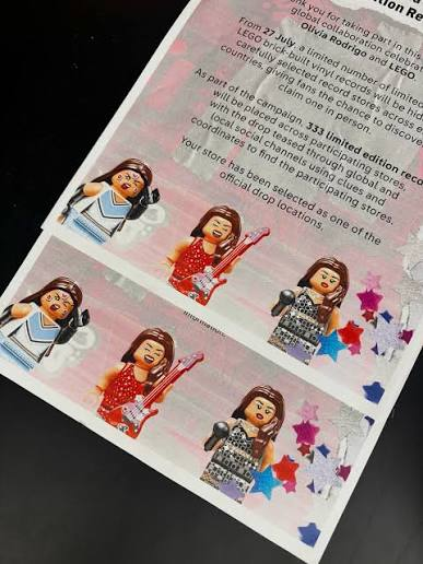 Close-up of the promotional LEGO Olivia Rodrigo vinyl record build on display inside a local record store.