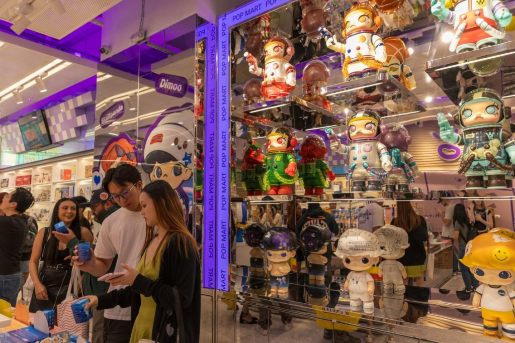 Interior view of the large Pop Mart flagship store at American Dream Mall in New Jersey featuring life-sized figures.